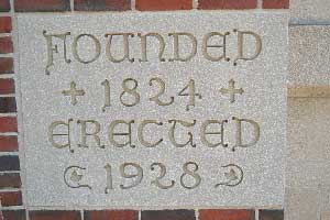 Datestone from Sanctuary building showing church's founding (1824) and building's construction (1928)