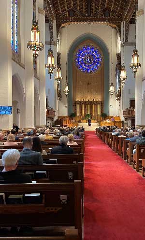 Interior of Sanctuary featuring large rose window.